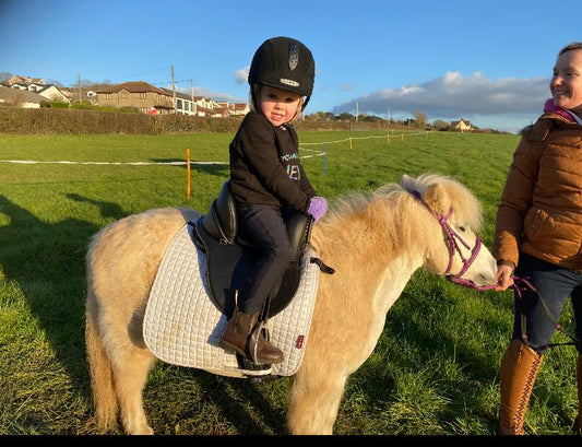 A kid is sitting on the horse with confident by using Criterion Versatile Horse Saddle.