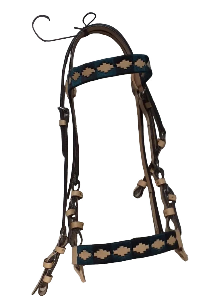 Brown and black leather horse bridle with decorative patterns on a tiled floor.