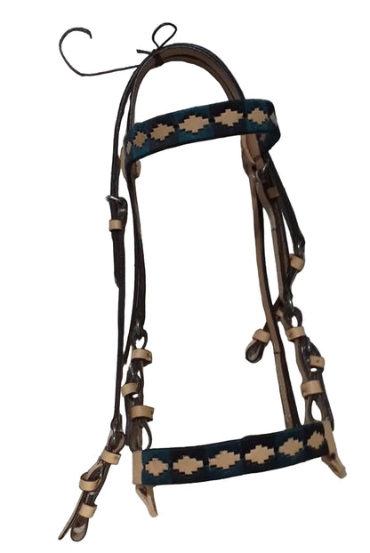 Brown and black leather horse bridle with decorative patterns on a tiled floor.