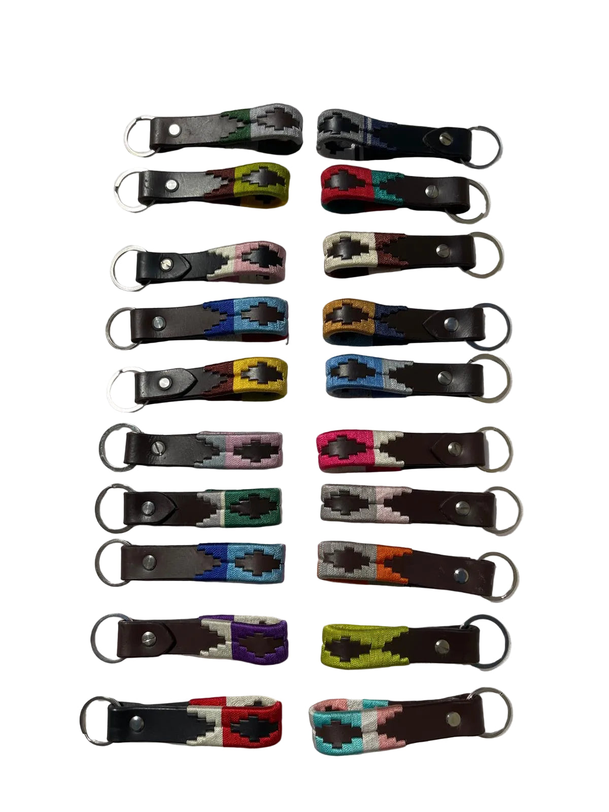 Set of colorful leather keychains on a white fabric background