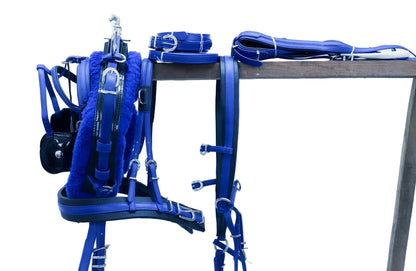 Blue equestrian tack including bridle, reins, and saddle pad on a stand against a white background